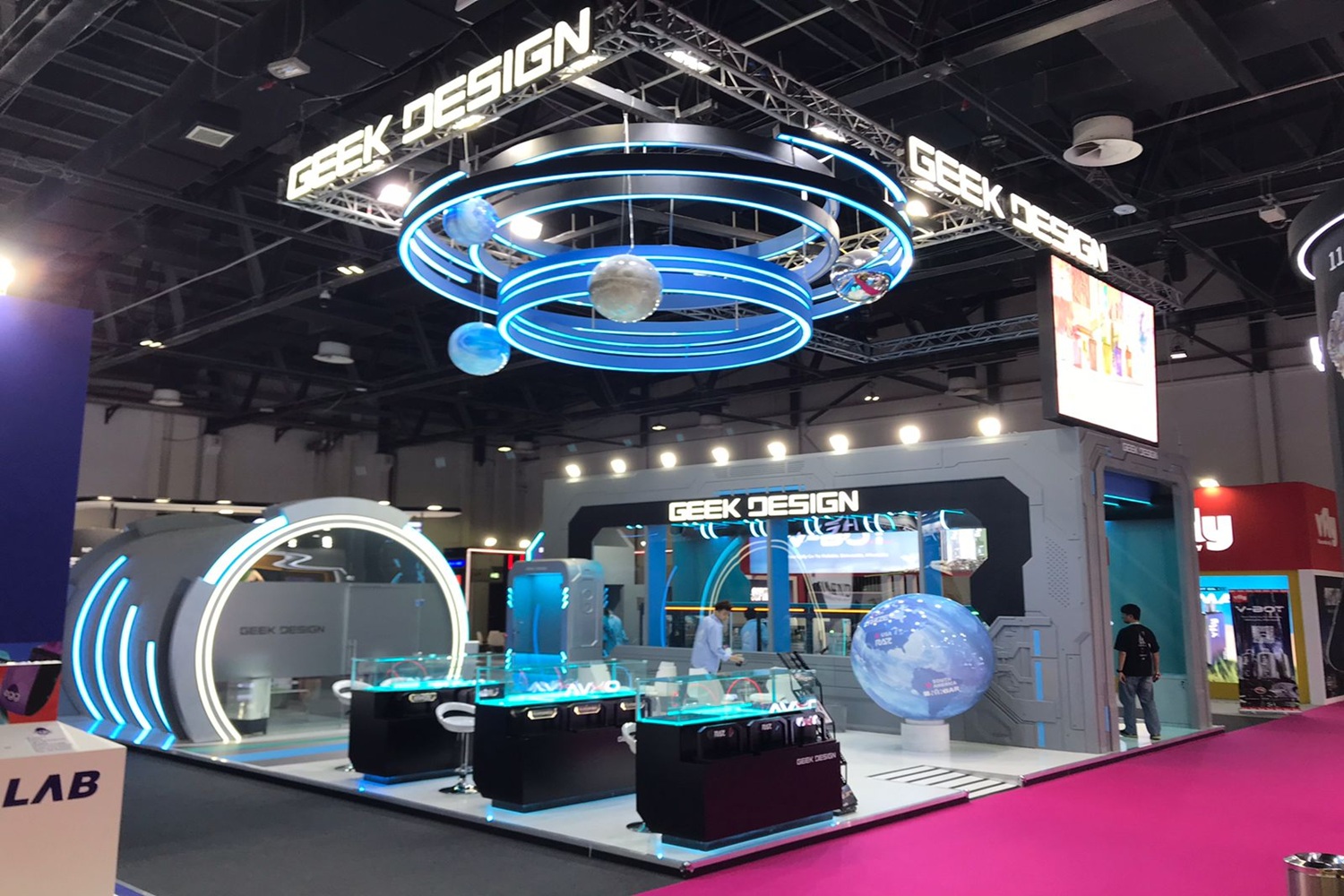 Exhibition stand showcasing products with vibrant yellow and green branding, featuring pasta packages displayed on shelves and a company logo with 'Company Since 1979' tagline.